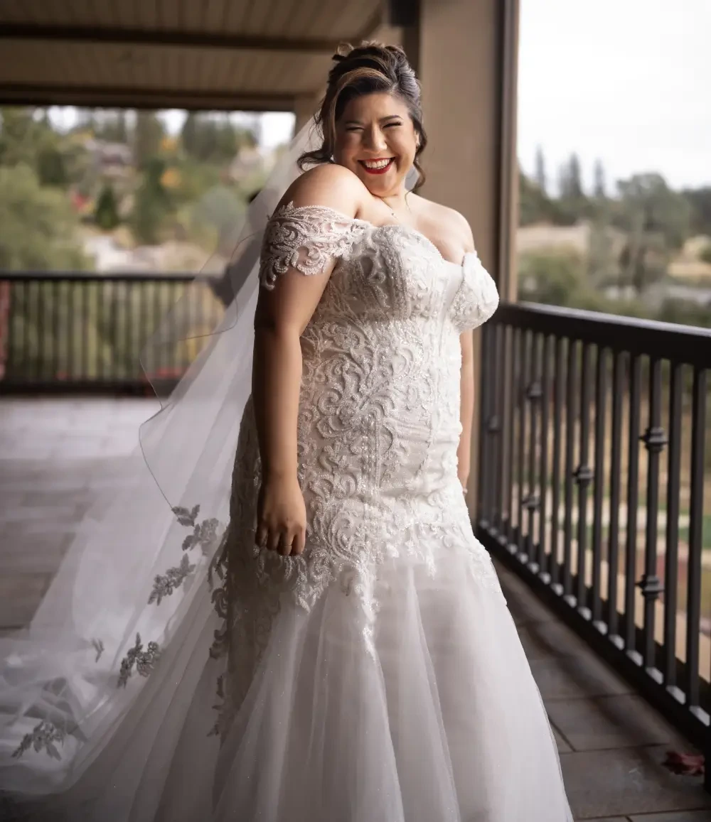 Model wearing a white curwy dress