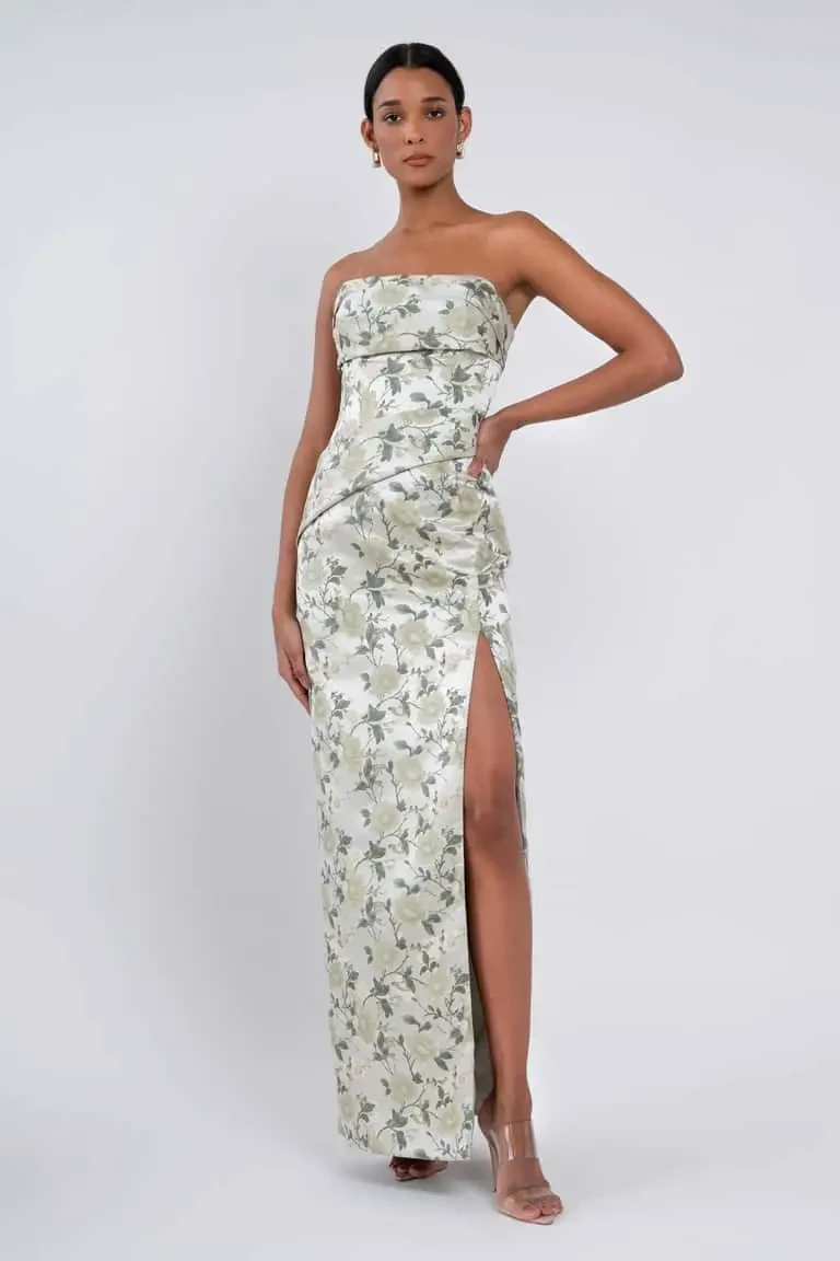 model is wearing a green and white floral bridesmaid dress by jenny yoo