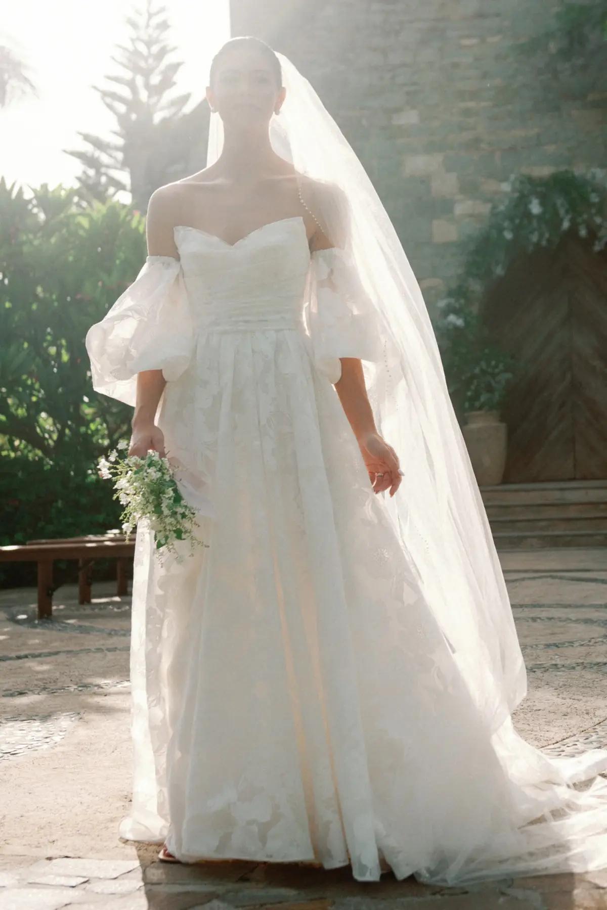 Model wearing a white gown by WToo