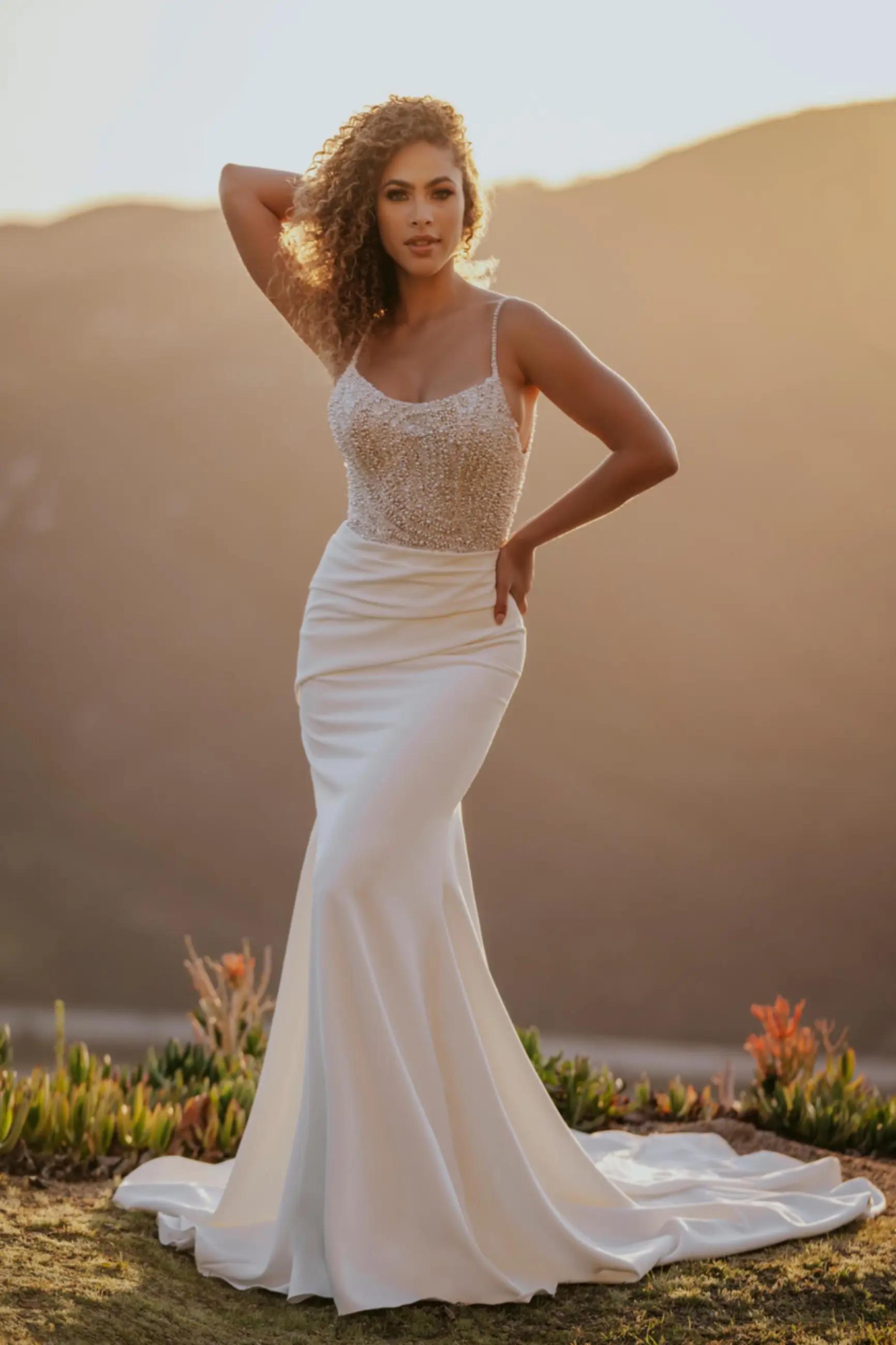 Model wearing a white gown by Allure Bridals